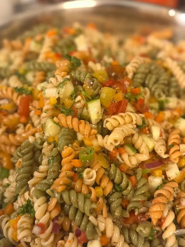Tri-color pasta salad with fresh vegetables