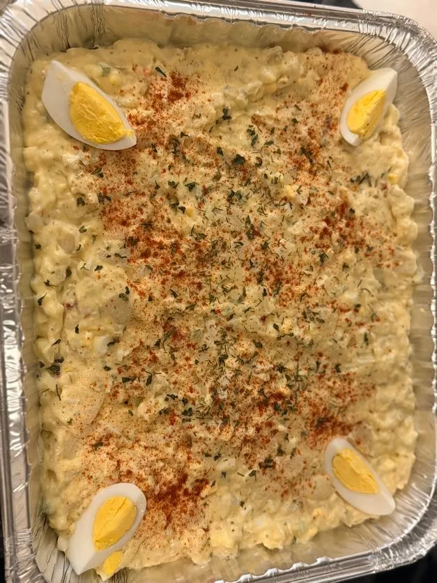 Classic potato salad topped with paprika and egg