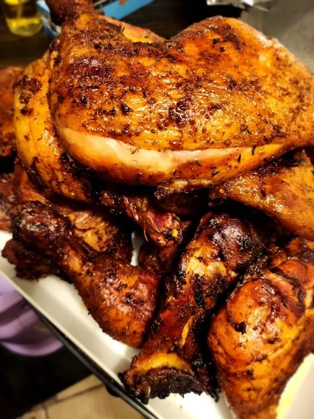 Platter of golden roasted and jerk-seasoned chicken
